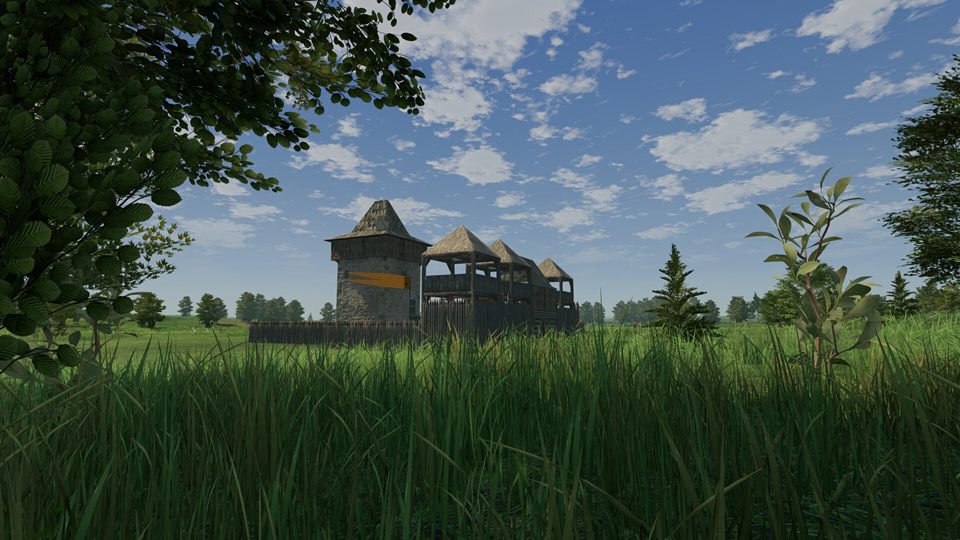 Screenshot: a timber keep and wooden walkways behind a palisade, seen from the tall grass beneath a leafy branch