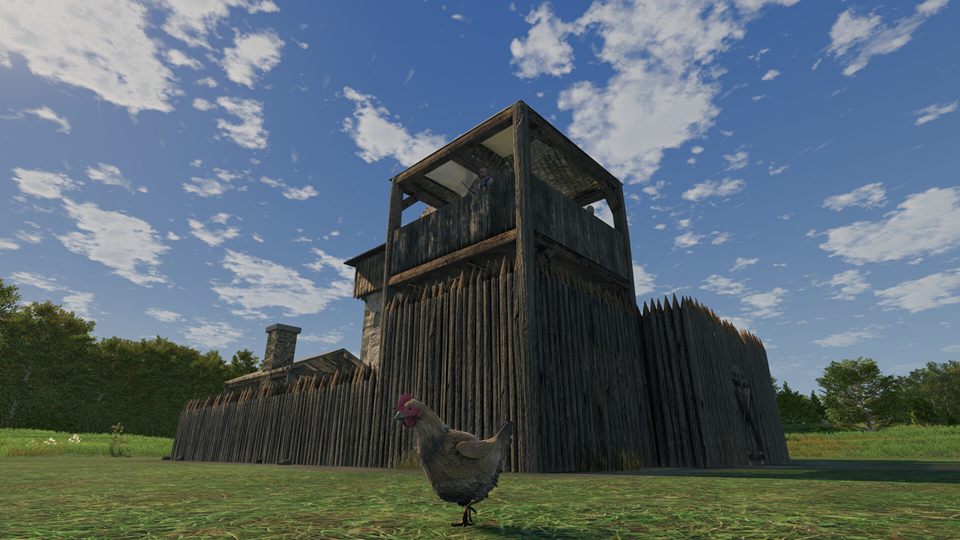 Screenshot: a wooden watchtower behind a sharpened palisade, a chicken strutting across the grass in front